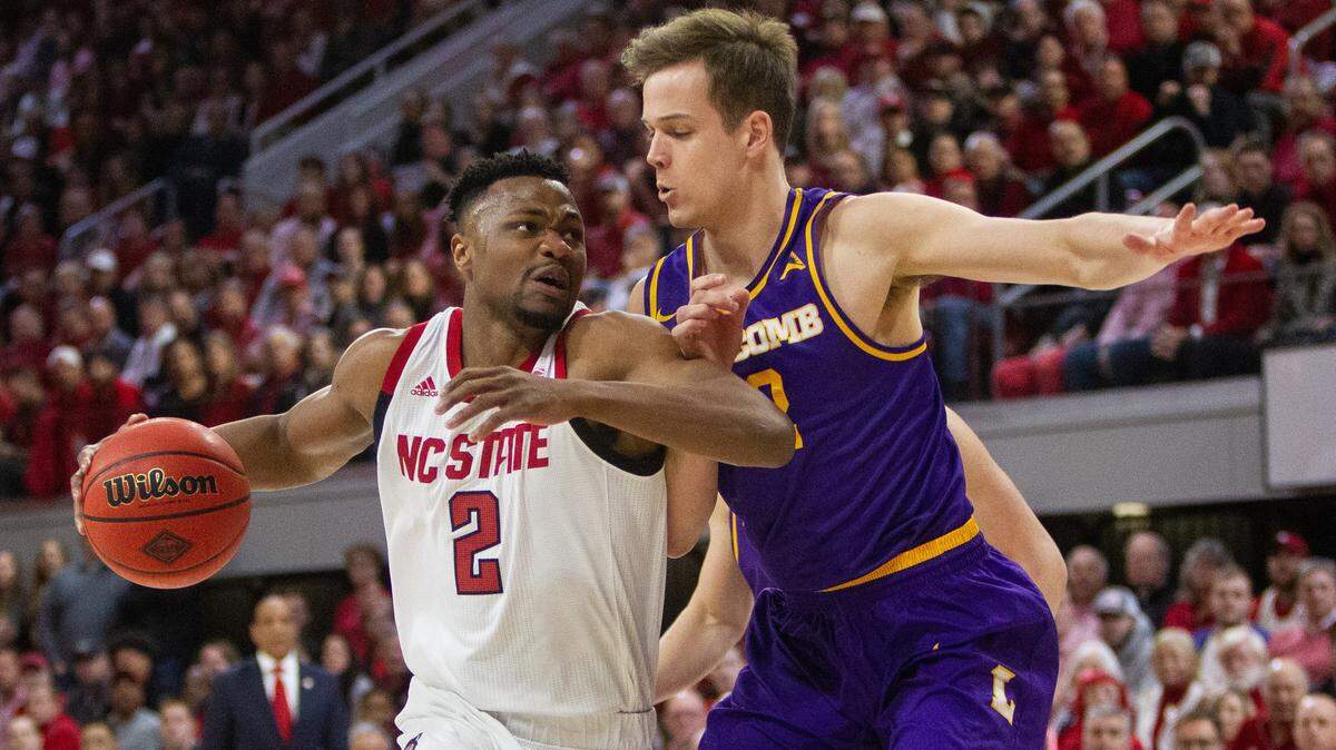 N.C. State’s Torin Dorn (2) maneuvers past Lipscomb’s Matt Rose (12)during the first half of the quarterfinals of the NIT on Wednesday night, March 27, 2019 at Reynolds Coliseum in Raleigh, NC.