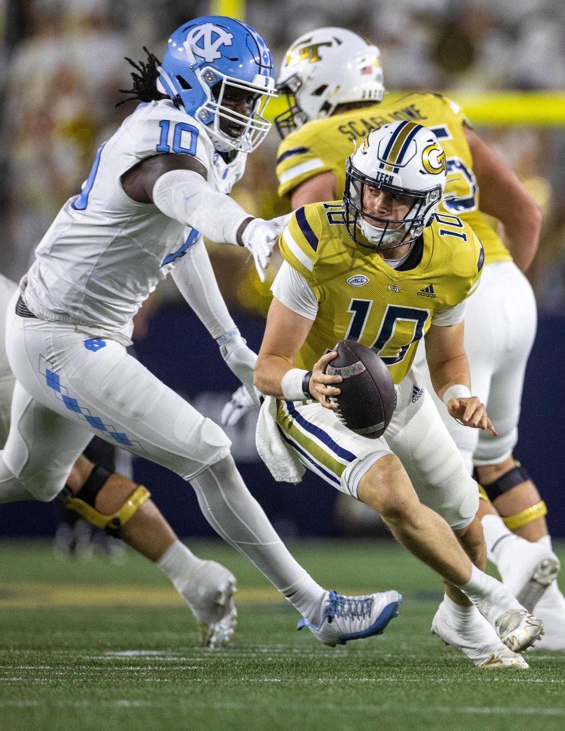 North Carolina’s Desmond Evans (10) pressures Georgia Tech quarterback Haynes King (10) in the first quarter on Saturday, October 28, 2023 at Bobby Dodd Stadium in Atlanta, Georgia.