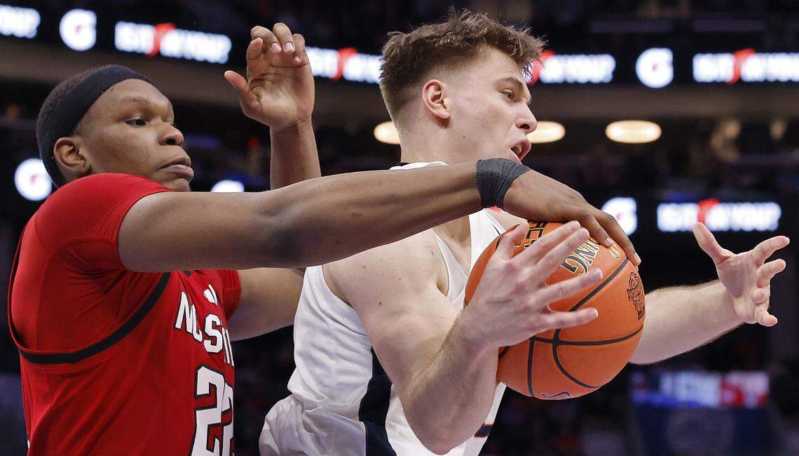 N.C. State's Ven-Allen Lubin pressures Virginia's Dallin Hall during the second half of the Wolfpack’s 81-74 loss in the ACC Tournament quarterfinals on Thursday, March 12, 2026, at the Spectrum Center in Charlotte, N.C. 