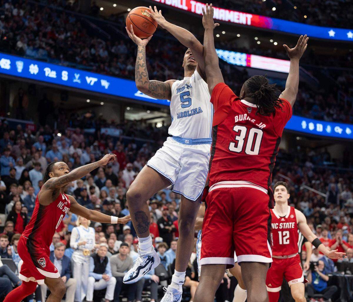 N.C. State’s D.J. Burns Jr. (30 defends North Carolina’s Armando Bacot (5) in the second half during the ACC Men’s Basketball Tournament Championship at Capitol One Arena on Saturday, March 16, 2024 in Washington, D.C.