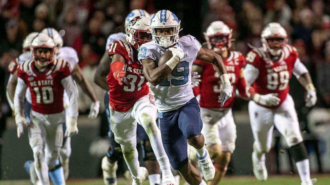 North Carolina running back Ty Chandler (19) breaks open for 35 yards in the fourth quarter against N.C. State on Friday, November 26, 2021 at Carter-Finley Stadium in Raleigh, N.C