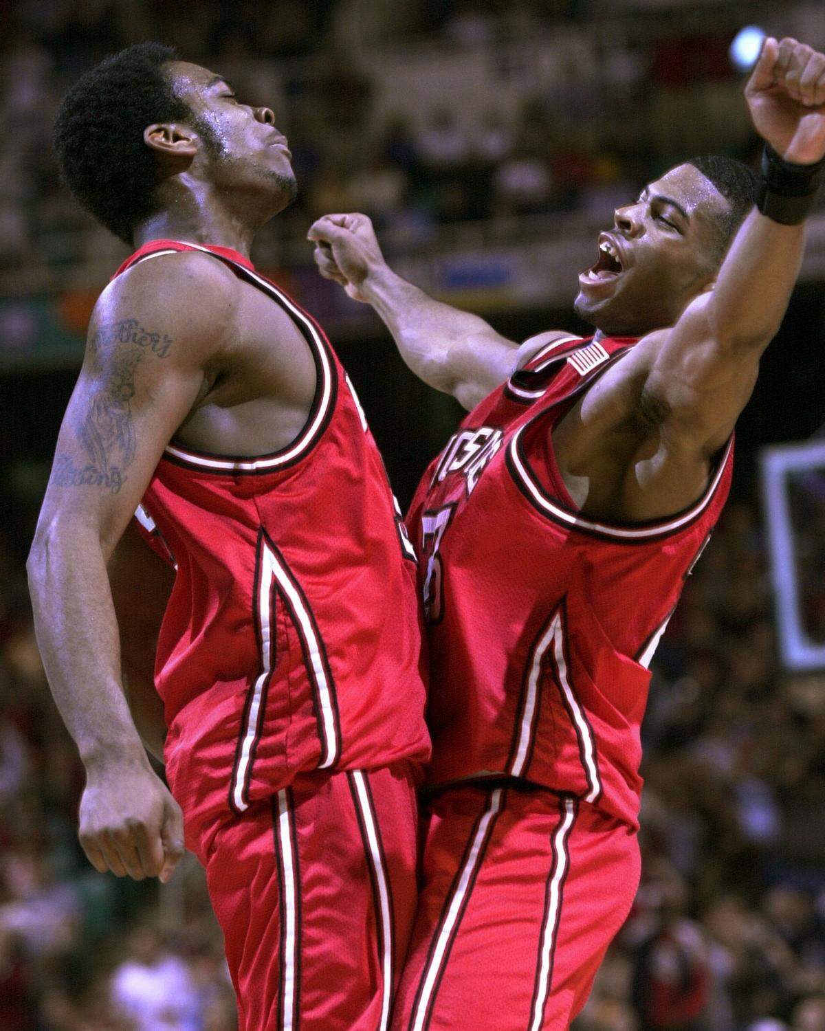 N.C. State's Josh Powell (left) and Scooter Sherrill bump chests after Powell scored in the second half of the ACC Tournament championship game against duke at the Greensboro Coliseum.   Powell led State with 26 points but Duke won 84-77.  