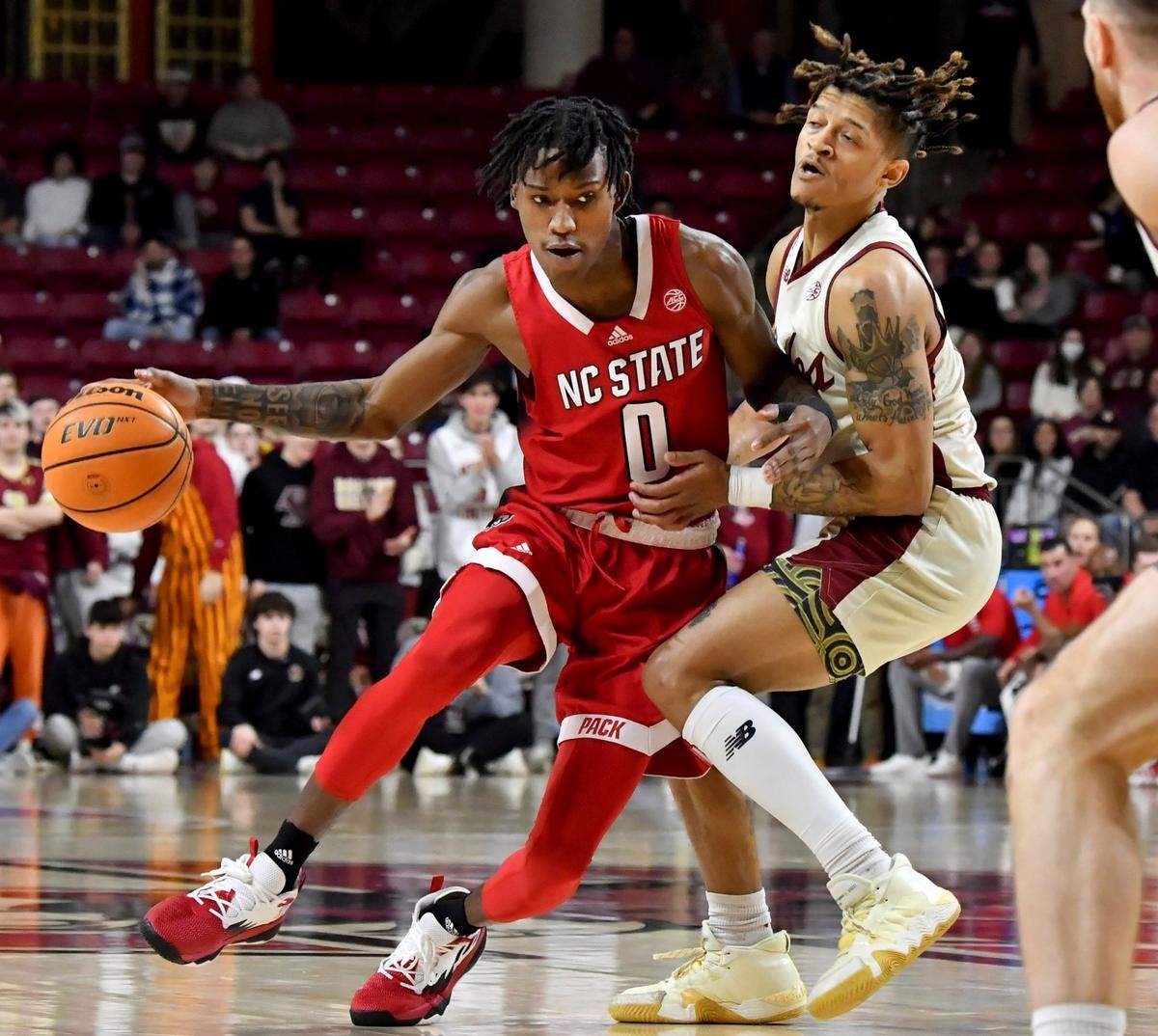 North Carolina State’s Terquavion Smith (0) bumps into Boston College’s Makai Ashton-Langford (11) during the first half of an NCAA college basketball game, Saturday, Feb. 11, 2023, in Boston. (AP Photo/Mark Stockwell)