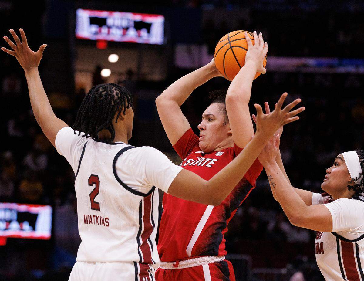 N.C. State’s Mimi Collins is pressured by South Carolina’s Ashlyn Watkins and Te-Hina Paopao during the first half of the Wolfpack’s 78-59 Final Four loss at Rocket Mortgage FieldHouse on Friday, April 5, 2024, in Cleveland, Ohio.