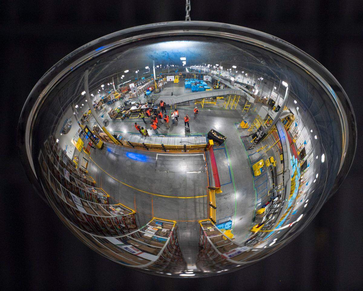The Amazon Same-Day Delivery Fulfillment Center in Durham is reflected in a mirror above the shelves where larger items are stored.