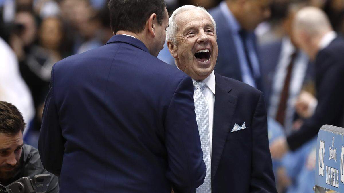 North Carolina head coach Roy Williams laughs with Duke head coach Mike Krzyzewski before Duke’s game against UNC at the Smith Center in Chapel Hill, N.C., Saturday, Feb. 8, 2020.