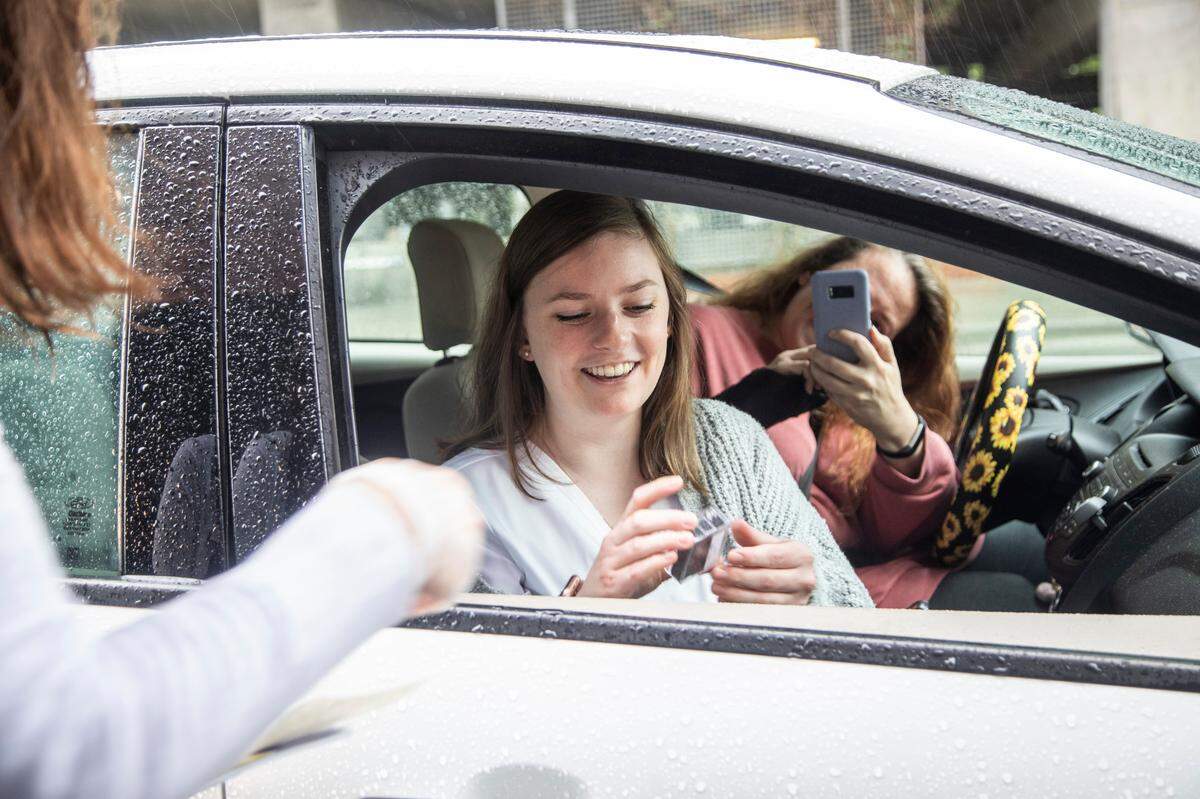 Caitlin Lewis is filmed by her mother Belina Anastasi during a drive-through pinning ceremony for the Wake Tech Community College Martha Mann Smith School of Nursing graduates Monday morning, April 20, 2020. Sixty four nursing students graduated program with nursing degrees Monday.
