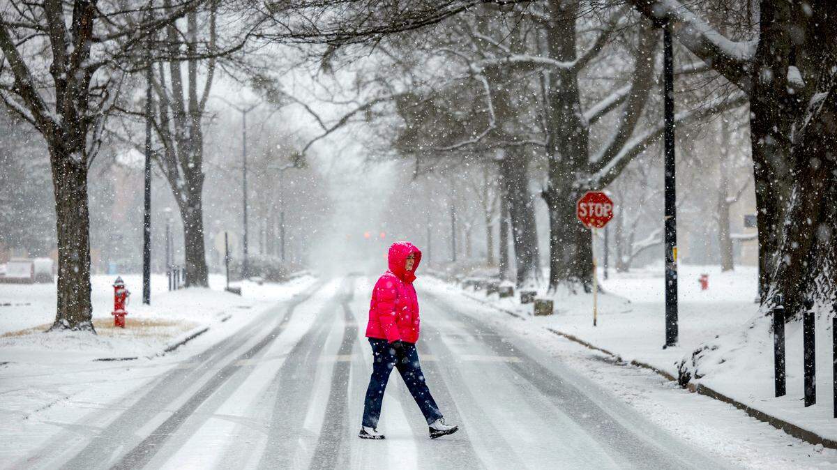 University of North Carolina student Ashton Jarman walks across snow covered Cameron Avenue on campus as a winter storm moves through the area on Wednesday, February 19, 2025 in Chapel Hill, N.C.