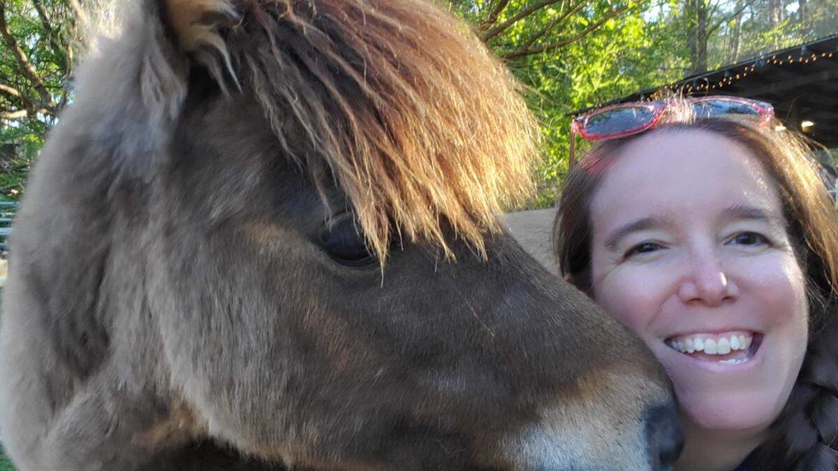 Emily Haas and her miniature horse Mocha, who survived a bout with botulism thanks to NC State veterinarians