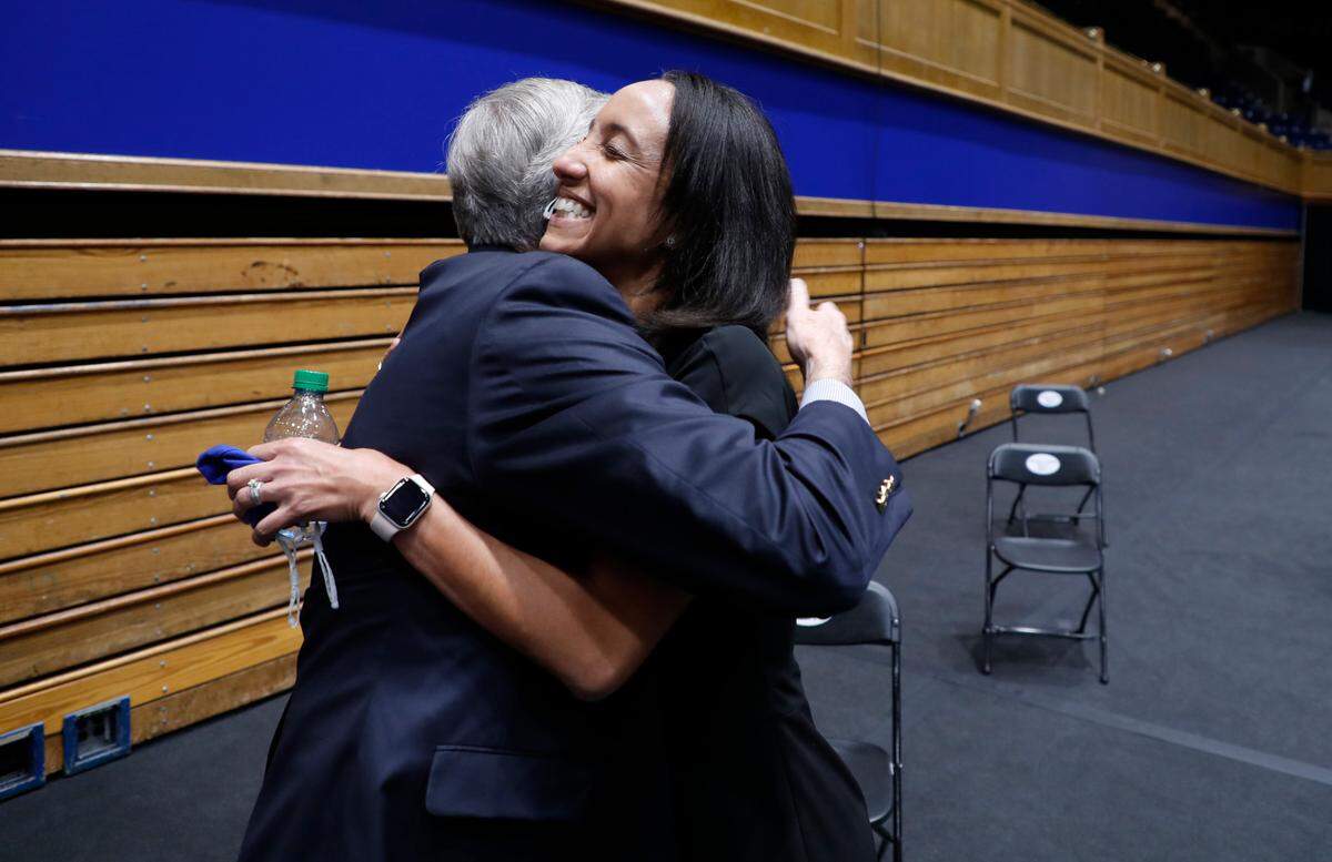 New Duke Athletic Director Nina King hugs outgoing Duke Athletic Director Kevin White after a press conference at Cameron Indoor Stadium in Durham, N.C., Friday, May 21, 2021.