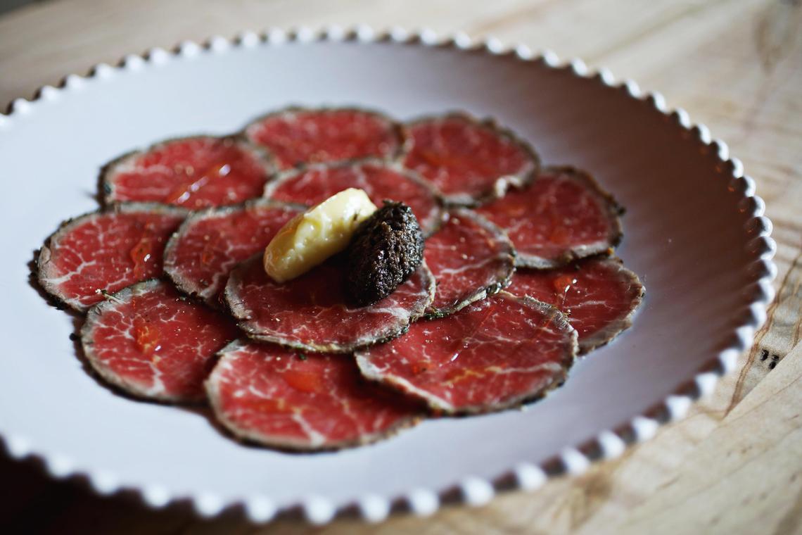The filet mignon beef carpaccio is served with Cucciolo aioli and truffle paste at Cucciolo Osteria in Durham.