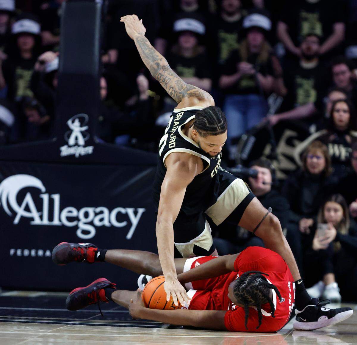 N.C. State’s D.J. Burns Jr. (30) gets to the loose ball before Wake Forest’s Davion Bradford (20) can during the first half of N.C. State’s game against Wake Forest at Joel Coliseum in Winston-Salem, N.C., Saturday, Jan. 28, 2023.