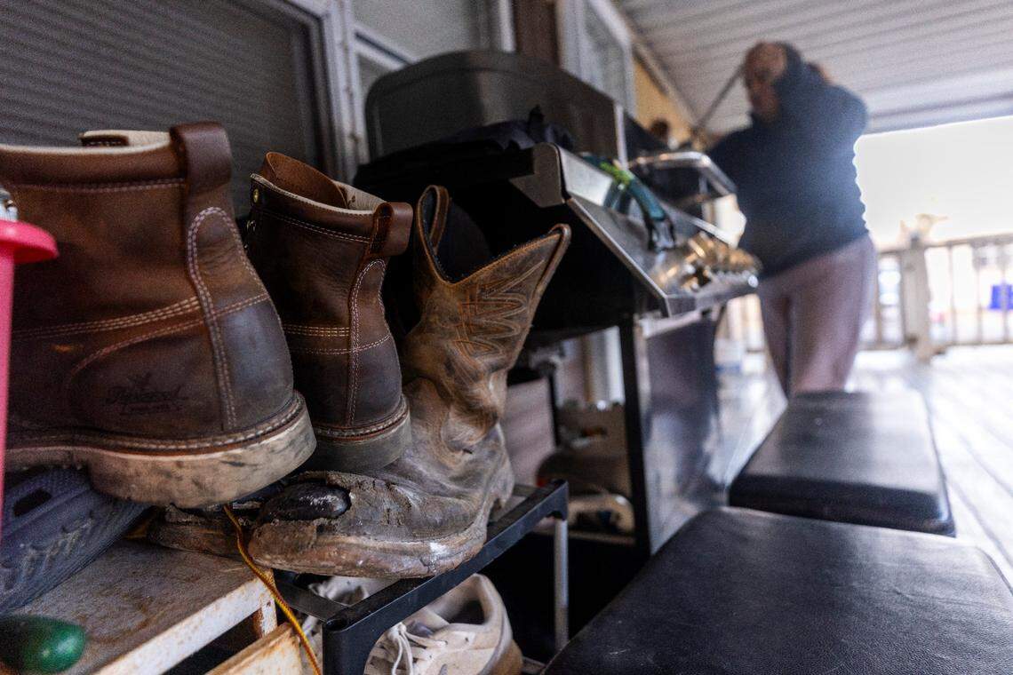 A woman who immigrated from Guatemala cooks on a propane grill at her home in Durham.