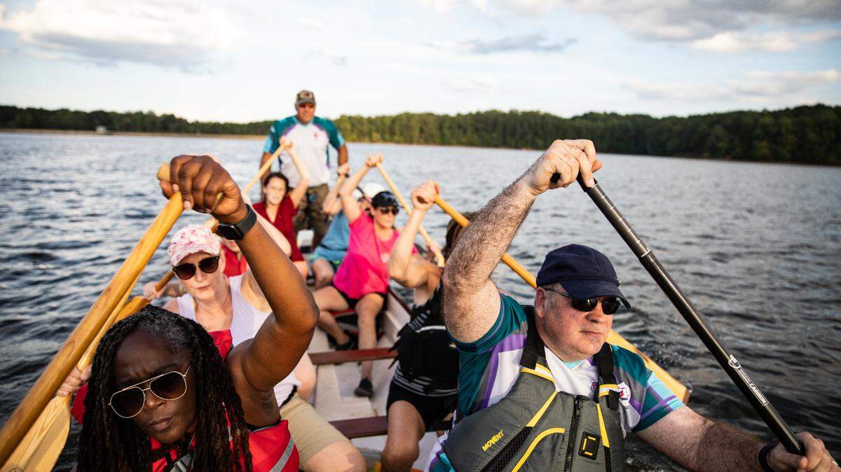A team of Chemo-Kazes synchronizes their paddling out on the water at Lake Wheeler at practice Sept. 4, 2022. The group is made up of survivors of cancer or other illnesses and their caregivers.