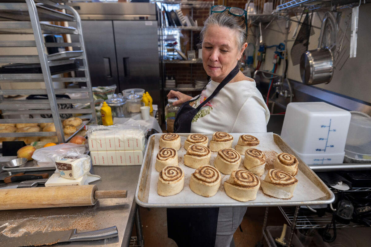Susan Scoggins prepares a tray of her prized cinnamon rolls in the kitchen at the Carriage House Sundries on Tuesday, March 11, 2025 in Burnsville, N.C.. Her former bakery, in Micaville was destroyed by flooding from Hurricane Helene.