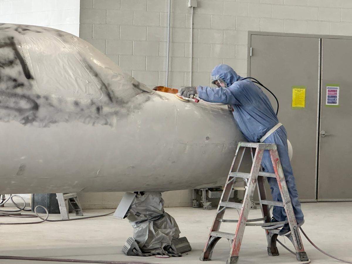 A worker removes paint from a small jet at flyExclusive in the N.C. Global TransPark in Kinston. The company has about 500 workers in the TransPark, making it the park’s largest employer.