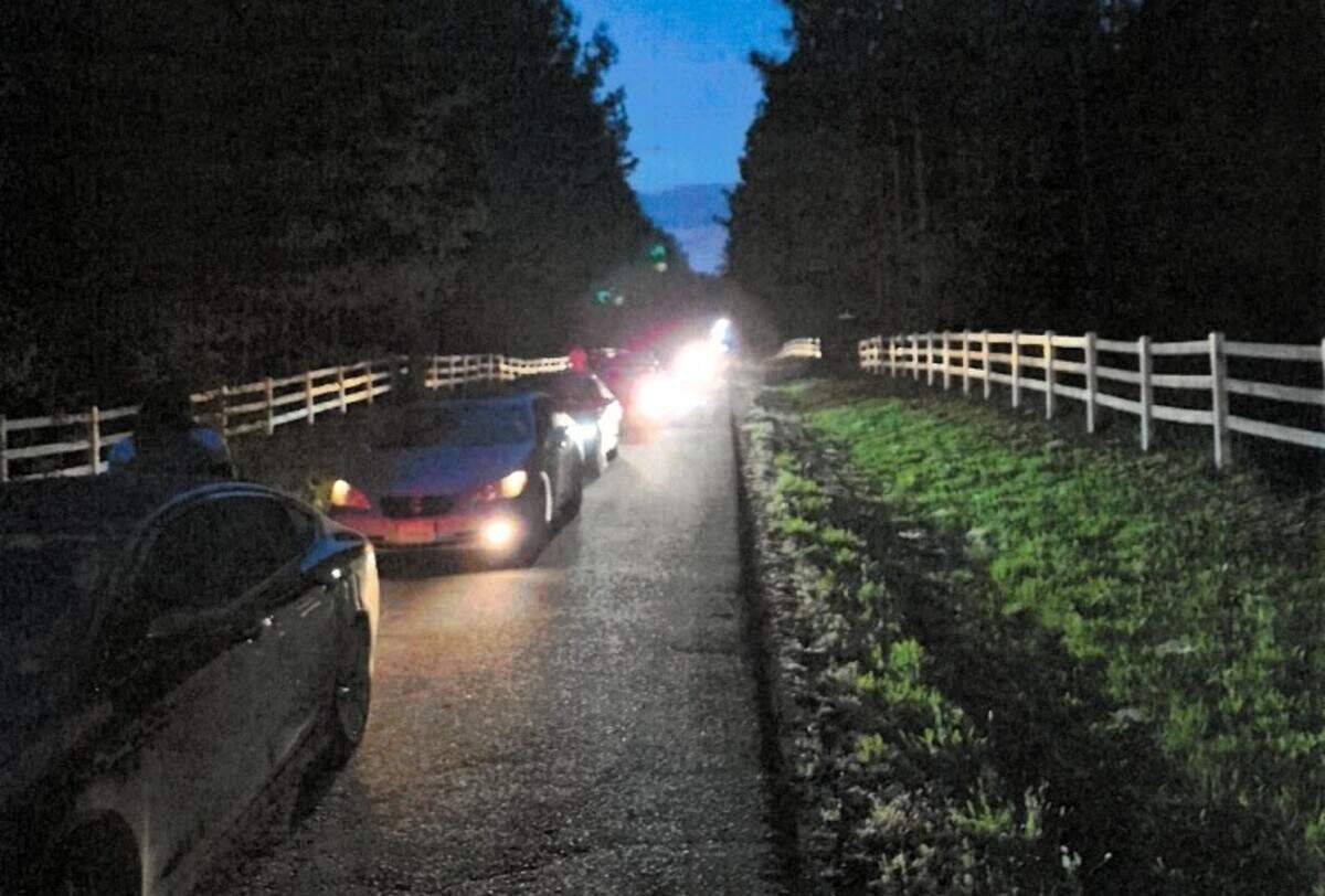 Cars line the road to F7 BlackStone Ranch as night falls on Scottland Drive in western Orange County, NC. One party at the venue was shut down because traffic blocked emergency access, Orange County sheriff’s officials said.