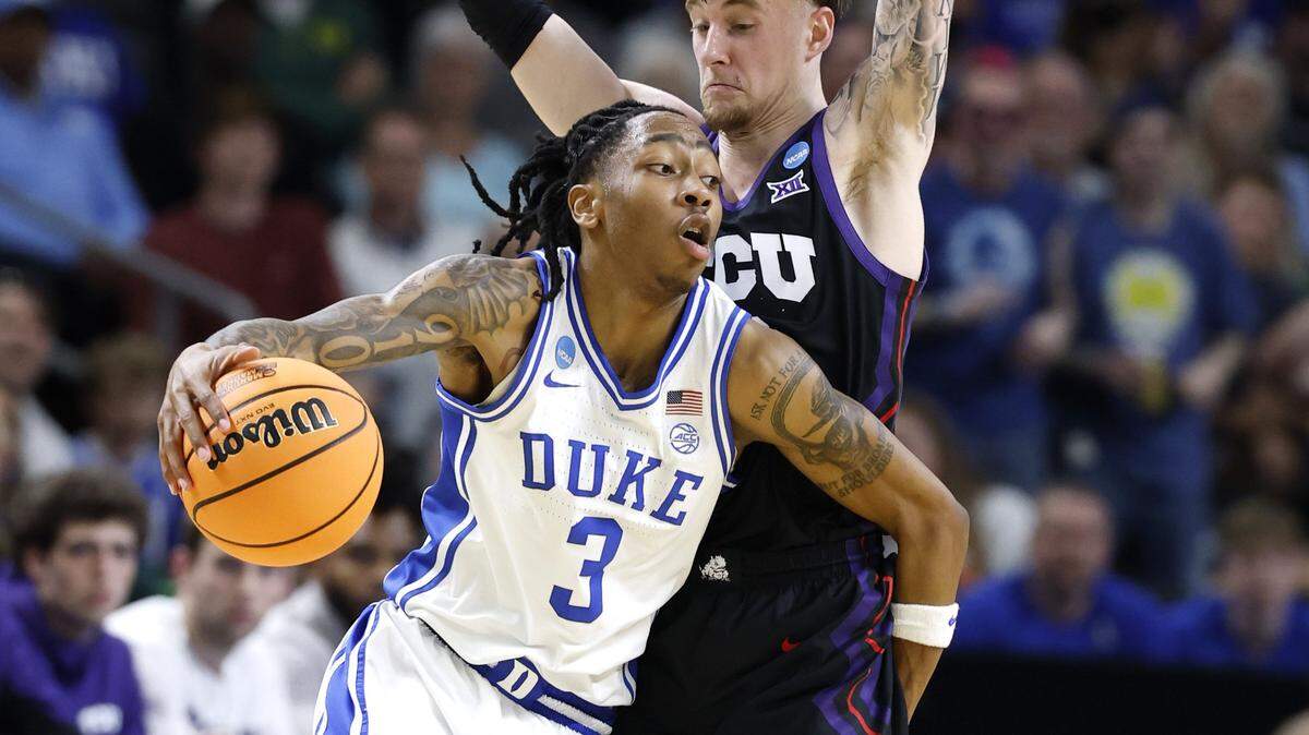 Duke’s Isaiah Evans (3) drives around TCU’s Brock Harding (2) during the first half of Duke’s game against TCU in the second round of the NCAA Men’s Basketball Tournament at  Bon Secours Wellness Arena in Greenville, S.C., Saturday, March 21, 2026.