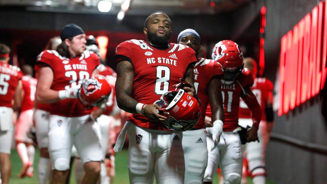 N.C. State running back Ricky Person Jr. (8) and teammates head to the field to warmup before N.C. State’s game against Liberty at Carter-Finley Stadium in Raleigh, N.C., Saturday, Nov. 21, 2020.