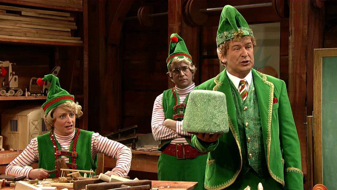 (L-R) Rachel Dratch, Fred Armisen and Alec Baldwin in the “Saturday Night Live” “Glengarry Christmas” sketch.