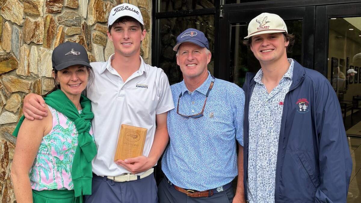 The Neal family, from left, Holly, Andrew, David and Walker, pose for a photo after Andrew earned co-medalist honors at the NCISAA 3A state tournament.