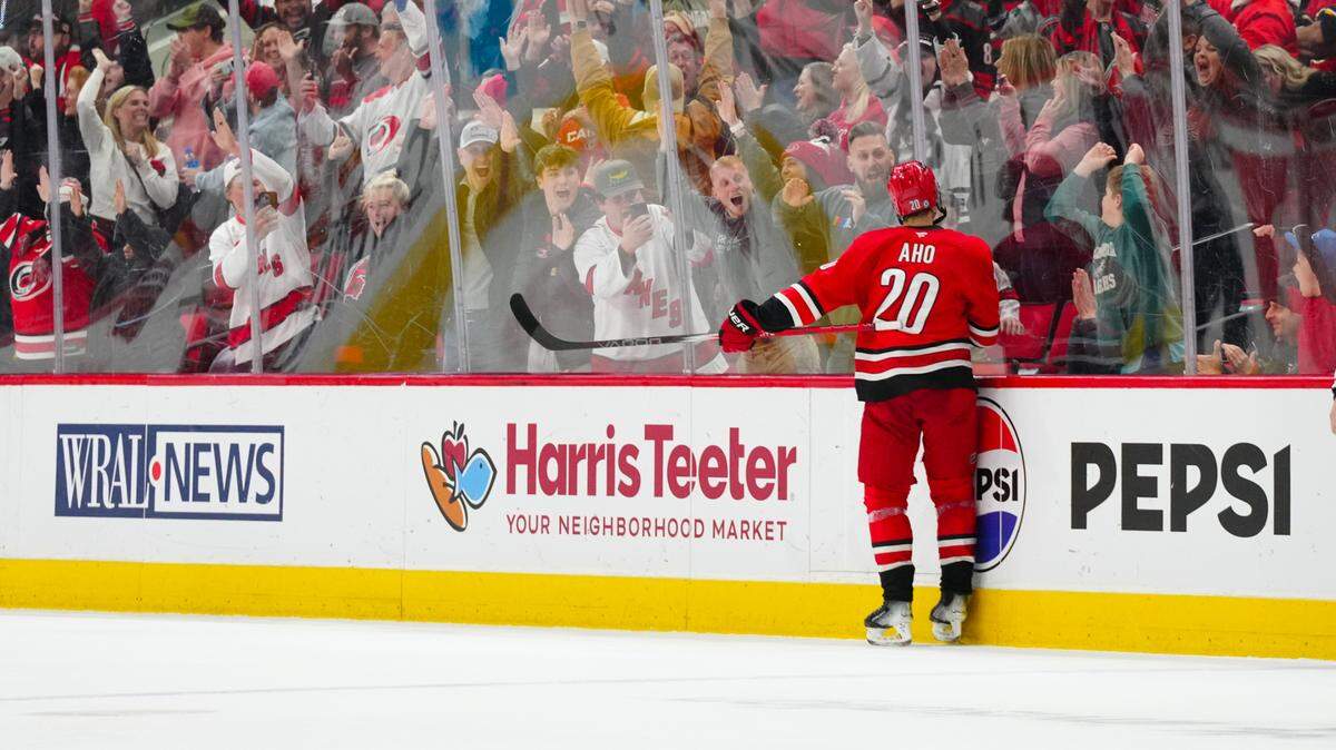 Carolina Hurricanes center Sebastian Aho (20) celebrates his game winning goal in the overtime against the Calgary Flames at Lenovo Center.