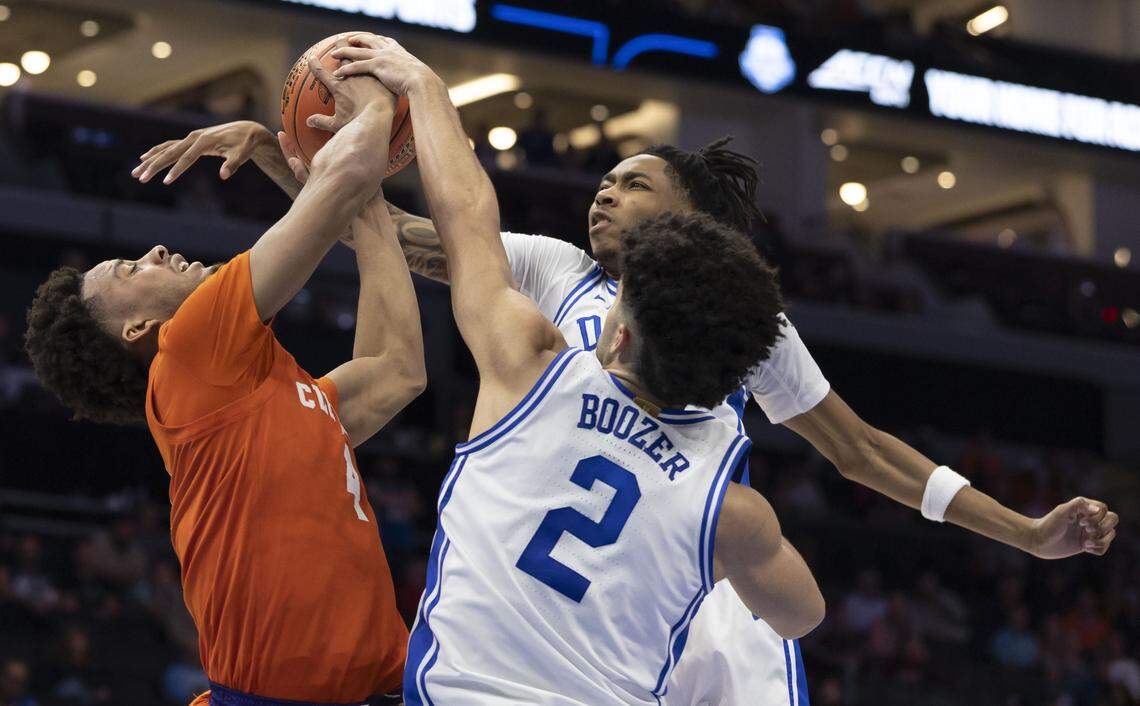 Duke forwards Isaiah Evans (3) and Cameron Boozer (12) defend Clemson guard Efrem Johnson (4) in the second half on Friday, March 13, 2026, during the semifinals of the ACC Tournament at Spectrum Center in Charlotte, N.C.