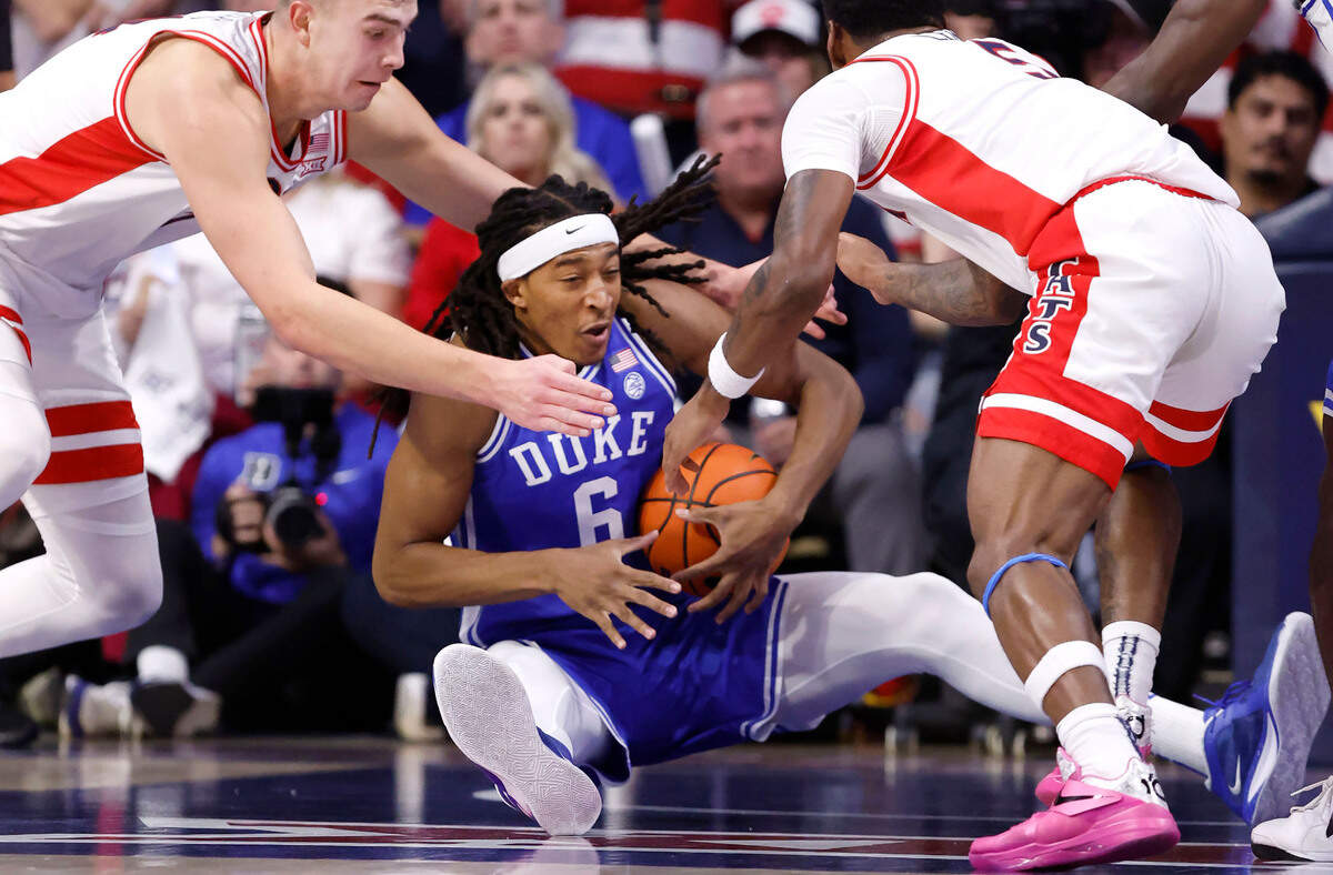 Duke’s Maliq Brown (6) pulls in the loose ball from Arizona’s Motiejus Krivas (14) and KJ Lewis (5) during the first half of Duke’s game against Arizona at the McKale Memorial Center in Tucson, Ariz., Friday, Nov. 22, 2024.