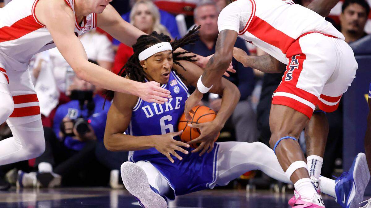 Duke’s Maliq Brown (6) pulls in the loose ball from Arizona’s Motiejus Krivas (14) and KJ Lewis (5) during the first half of Duke’s game against Arizona at the McKale Memorial Center in Tucson, Ariz., Friday, Nov. 22, 2024.