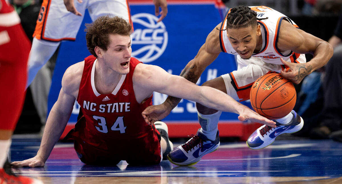 N.C. State’s Ben Middlebrooks (34) and Syracuse’s Judah Mintz (3) battle for a loose ball in the second half during the ACC Men’s Basketball Tournament at Capitol One Arena on Wednesday, March 13, 2024 in Washington, D.C.