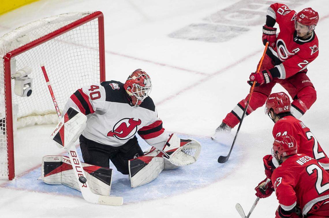 New Jersey Devils goalie Akira Schmid (40) deflects a scoring attempt by the Carolina Hurricanes Sebastian Aho (20) in the third period during Game 5 of their second round Stanley Cup playoff series on Thursday, May 11, 2023 at PNC Arena in Raleigh, N.C.
