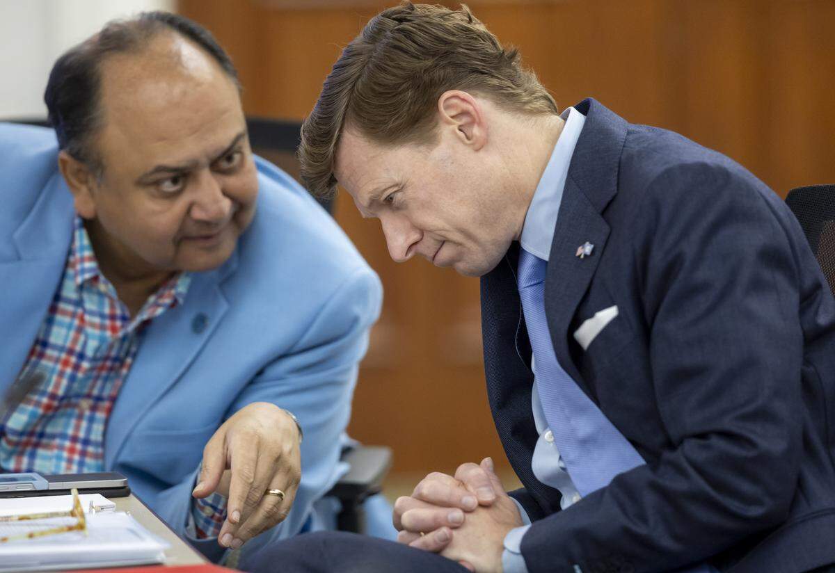 UNC Chancellor Lee Roberts confers with UNC Board of Trustees member Vinay Patel during their meeting on Tuesday, July 30, 2025 in Chapel Hill, N.C.