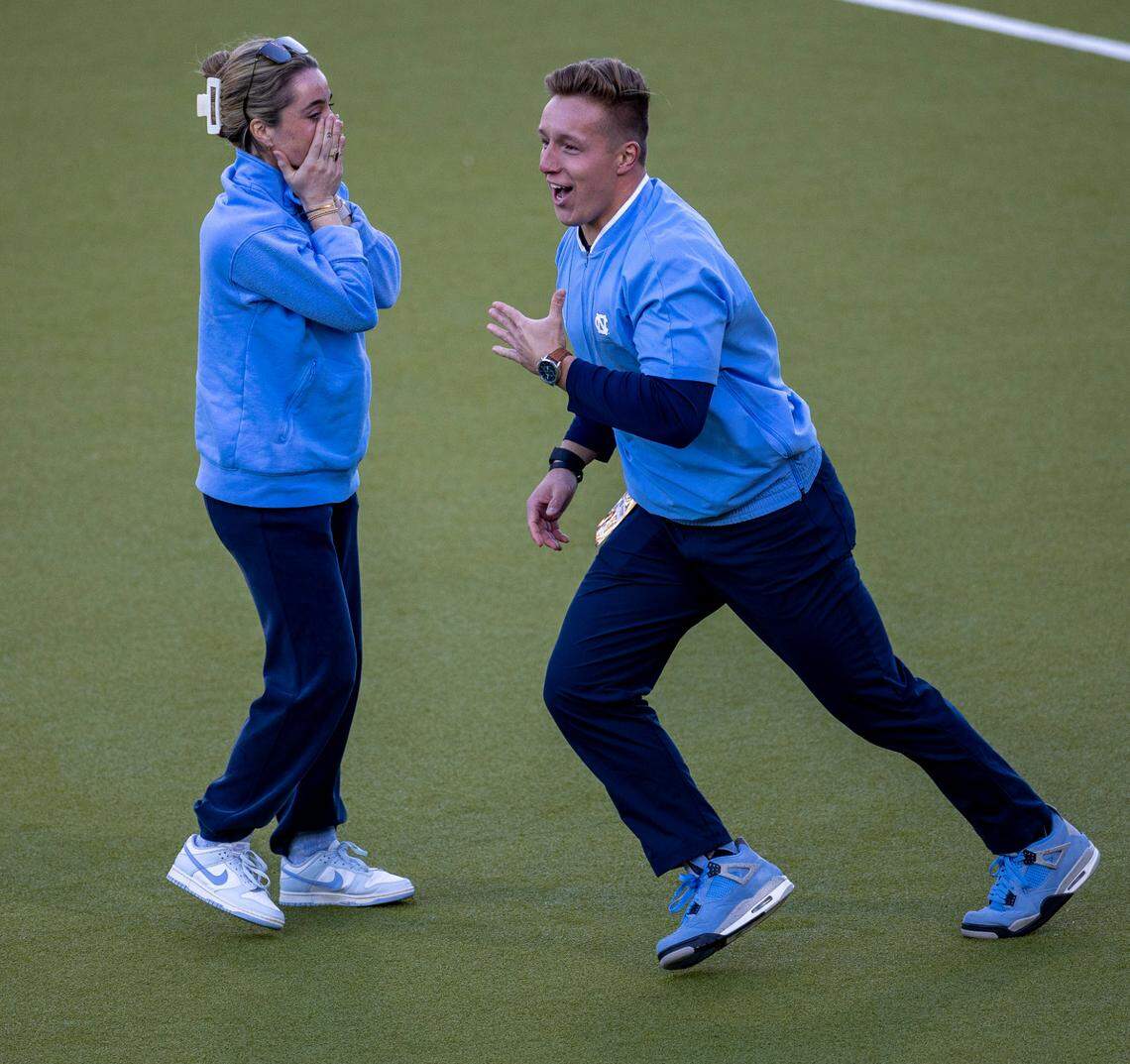 North Carolina coach Erin Matson and trainer Andrew Reynolds react after Katie Dixon (14) scored on Northwestern goalie Annabel Skubisz (30) in the sudden death shootout to clinch the NCAA Division I Field Hockey Championship on Sunday, November 19, 2023 at Karen Shelton Stadium in Chapel Hill, N.C.