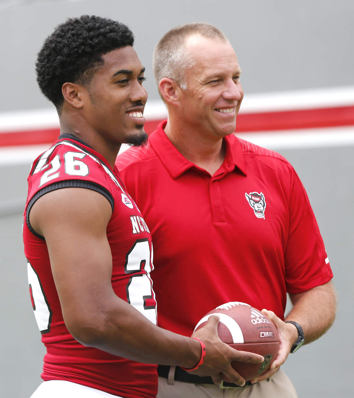 N.C. State coach Dave Doeren poses with Trent Pennix (26) during the Wolfpack’s media day in Raleigh, N.C., Sunday August 12, 2018.