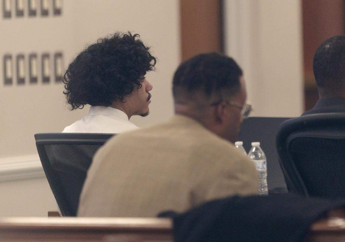 Issiah Ross, left, who is accused of killing 14-year-old Lyric Woods and 18-year-old Devin Clark listens Tuesday during his trial in Orange County Superior Court