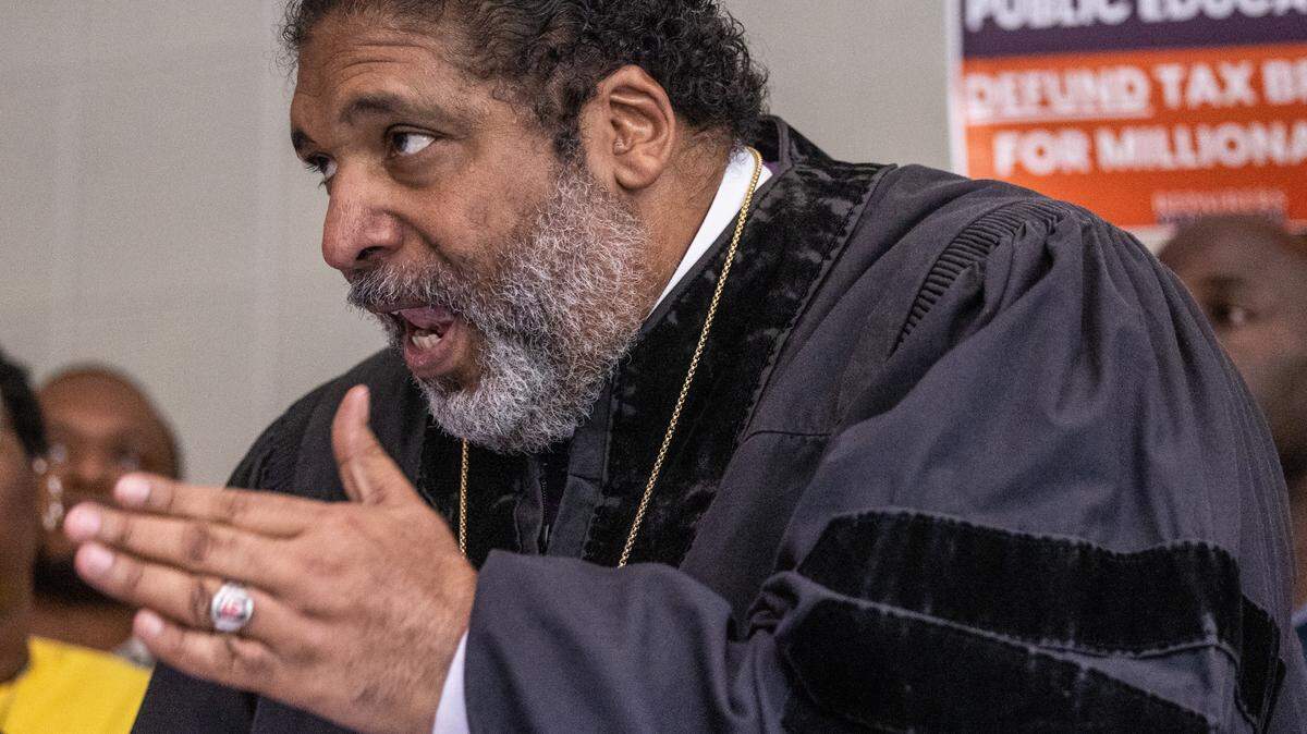 The Rev. William Barber II leads a rally of more than 100 demonstrators between entrances to the House and Senate chambers at the Legislative Building in Raleigh Wednesday, May 24, 2023.
