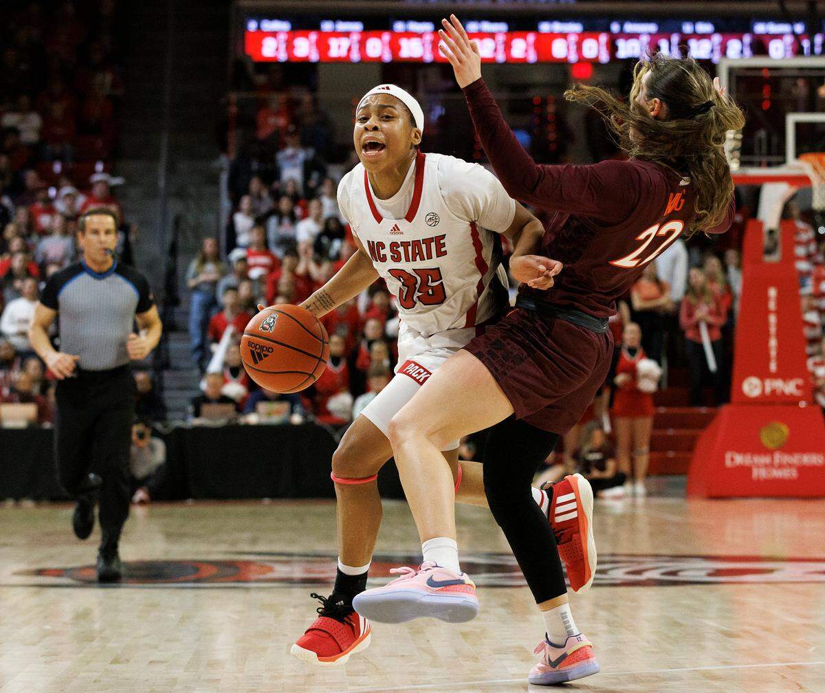 Virginia Tech’s Cayla King takes a charge against N.C. State’s Zoe Brooks during the second half of the Wolfpack’s 72-61 loss on Thursday, Feb. 8, 2024, at Reynolds Coliseum in Raleigh, N.C.