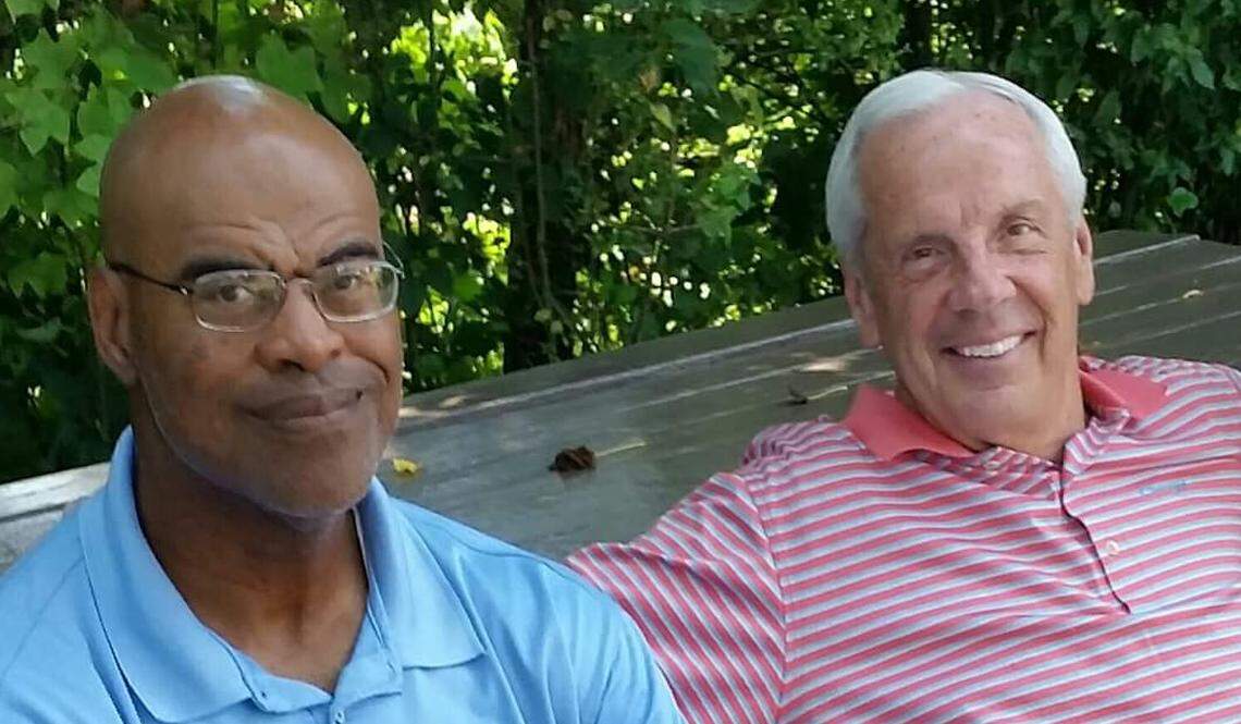 North Carolina men’s head basketball coach Roy Williams, right, sits with Porky Spencer, his long time friend who was a player on the first Williams-coached basketball team, at Owen High. Spencer attends nearly every UNC basketball game.
