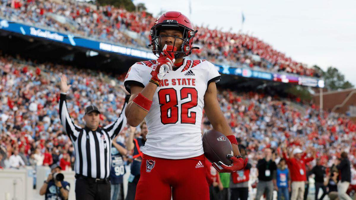 N.C. State wide receiver Terrell Timmons Jr. (82) shushes the crowd after scoring on a 28-yard touchdown reception during the first half of N.C. State’s game against UNC at Kenan Stadium in Chapel Hill, N.C., Friday, Nov. 25, 2022.