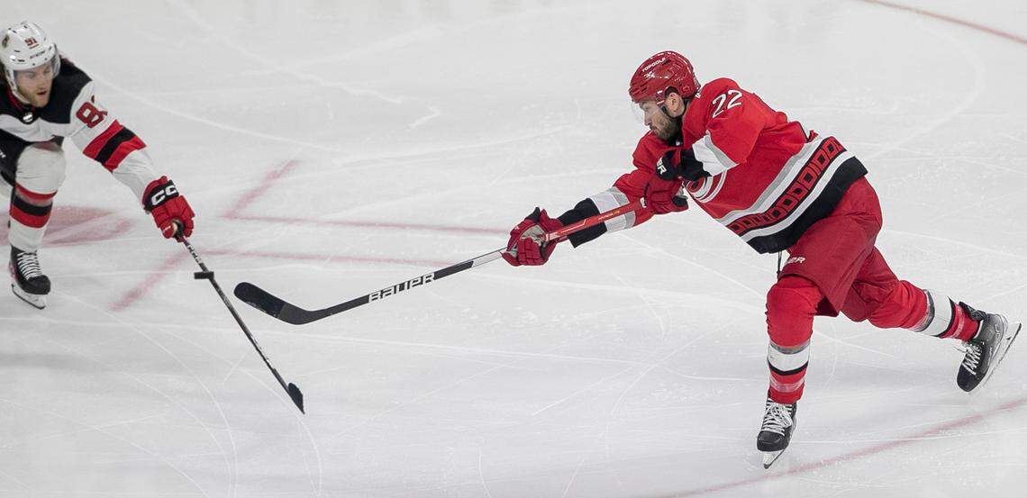 The Carolina Hurricanes Brett Pesce (22) fires a shot as New Jersey Devils Dawson Mercer (91) defends in the third period during Game 5 of their second round Stanley Cup playoff series on Thursday, May 11, 2023 at PNC Arena in Raleigh, N.C.