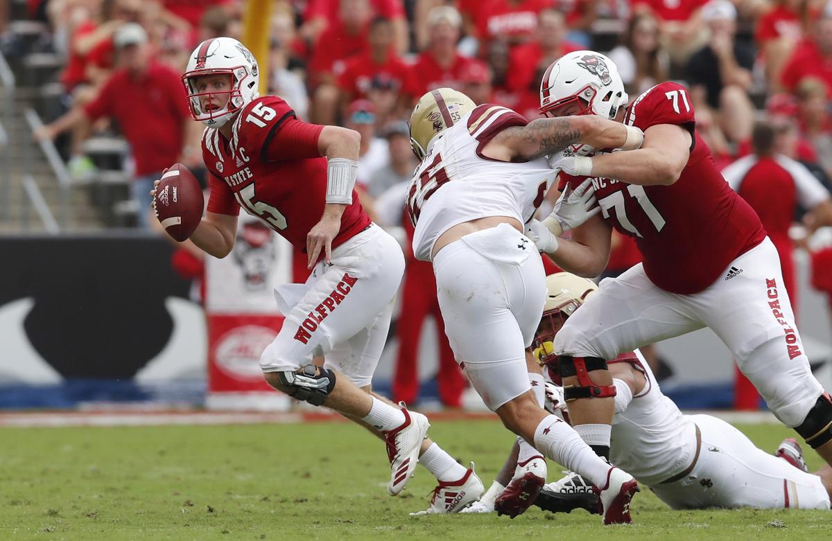 N.C. State quarterback Ryan Finley (15) escapes from the pressure by Boston College’s Isaiah McDuffie (55) during the first half of N.C. State’s game against Boston College at Carter-Finley Stadium in Raleigh, N.C., Saturday, Oct. 6, 2018.