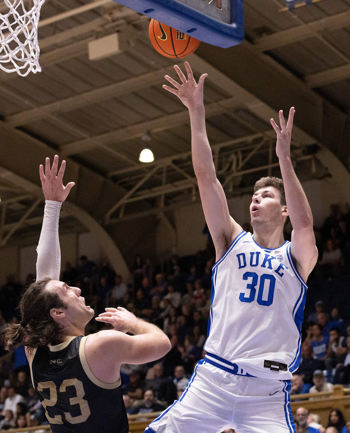 Duke’s Kyle Filipowski shoots over UNC Pembroke’s Steven Lassiter during the first half of the Blue Devils’ exhibition game on Wednesday, Nov. 1, 2023, at Cameron Indoor Stadium in Durham, N.C.