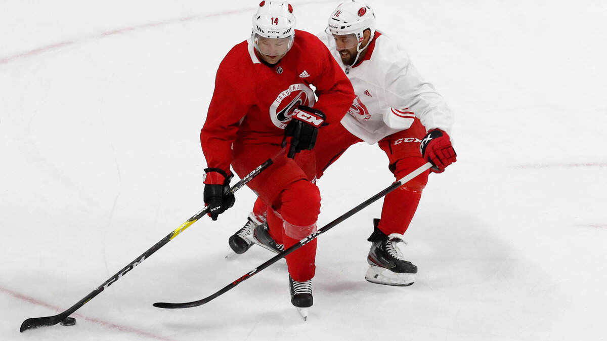 Carolina’s Justin Williams (14) brings the puck past Carolina center Vincent Trocheck (16) during the Carolina Hurricanes’ on-ice workout at PNC Arena in Raleigh, N.C., Monday, July 13, 2020.