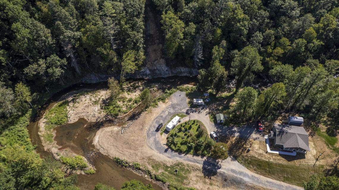 An aerial view of Lisa Thomas’s property in Spruce Pine on Aug. 29 shows where her former home once stood, at left, after flooding and a landslide destroyed it. Her new home, built on higher ground by Samaritan’s Purse, is pictured at right.