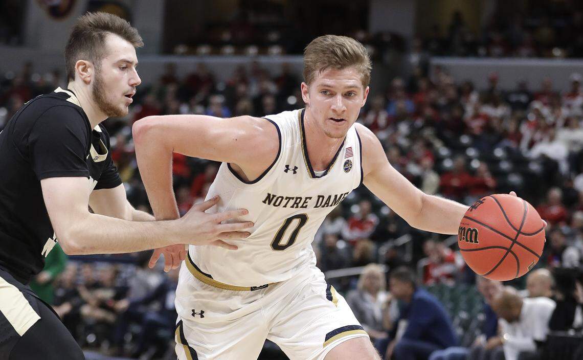 Notre Dame’s Rex Pflueger (0) goes to the basket against Purdue’s Sasha Stefanovic during the first half of an NCAA college basketball game, Saturday, Dec. 15, 2018, in Indianapolis.