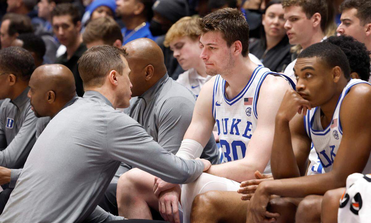 Duke head coach Jon Scheyer talks with Kyle Filipowski (30) during the second half of Duke’s 71-53 victory over Notre Dame at Cameron Indoor Stadium in Durham, N.C., Wednesday, Feb. 7, 2024.