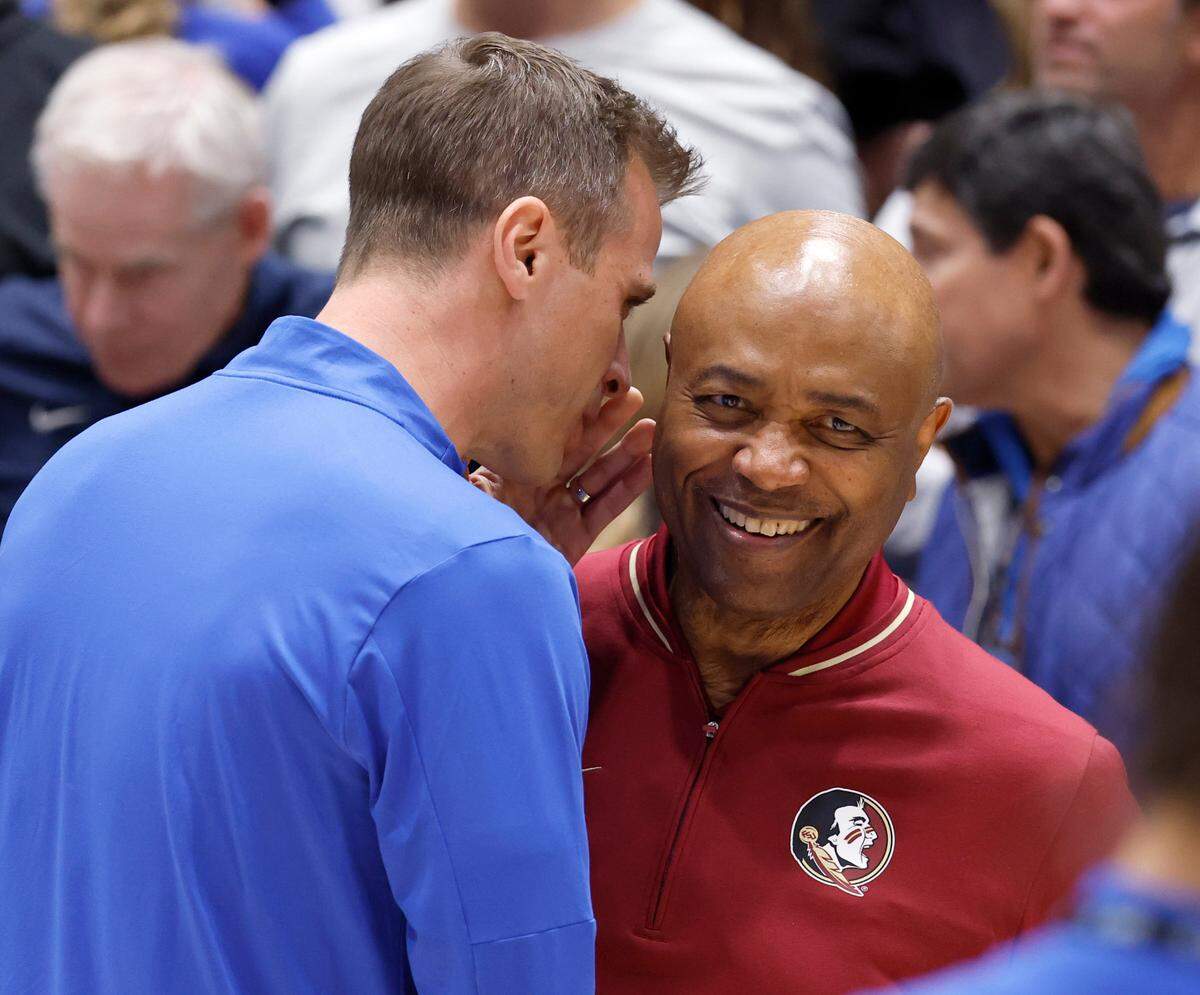 Duke head coach Jon Scheyer talks to Florida State head coach Leonard Hamilton before the start of Duke’s game against Florida State at Cameron Indoor Stadium in Durham, N.C., Saturday, March 1, 2025.