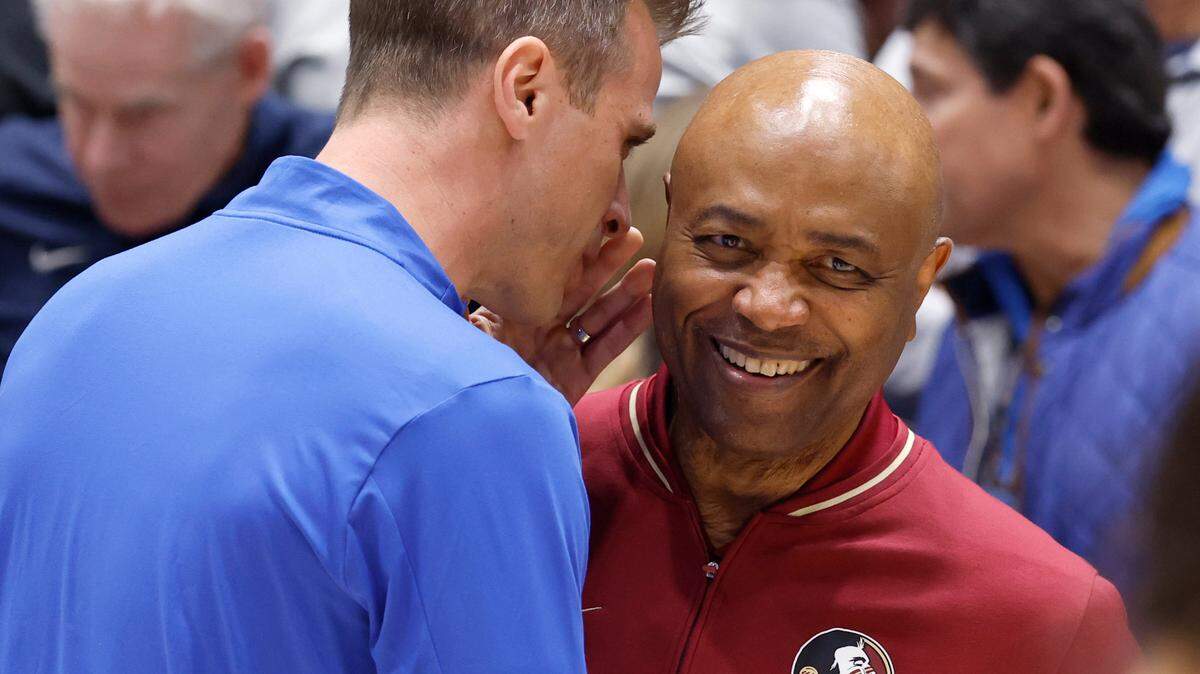 Duke head coach Jon Scheyer talks to Florida State head coach Leonard Hamilton before the start of Duke’s game against Florida State at Cameron Indoor Stadium in Durham, N.C., Saturday, March 1, 2025.