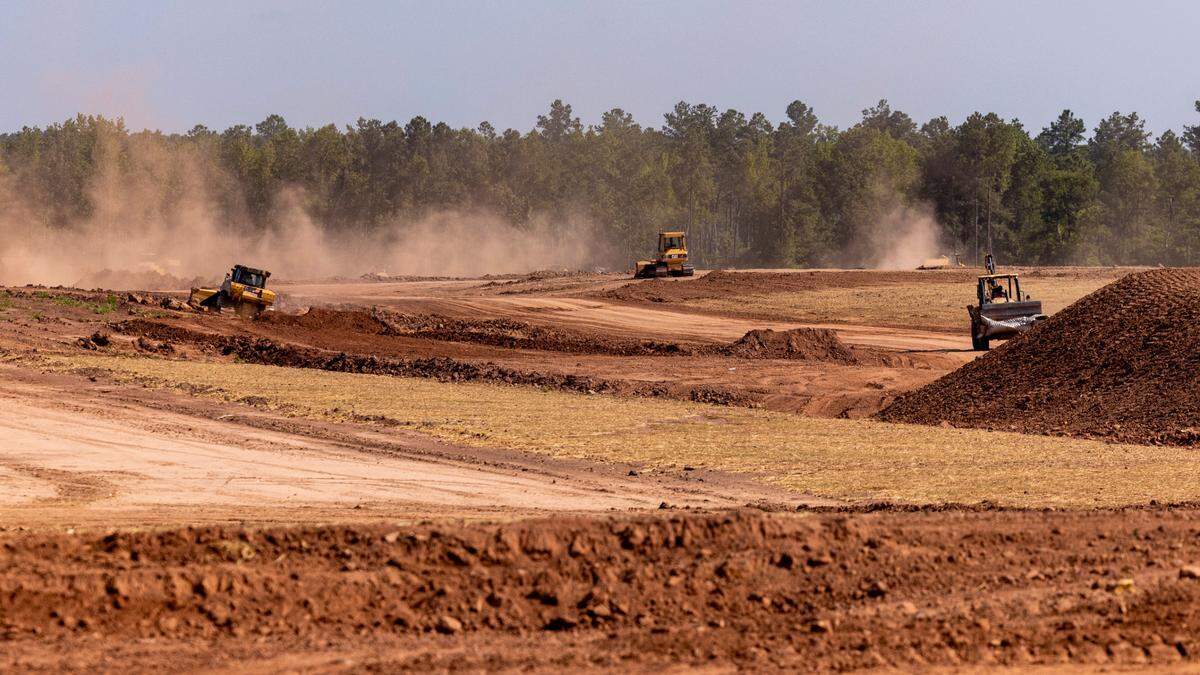 Bulldozers prepare the site for a proposed VinFast production facility Friday, July 28, 2023 in Moncure.