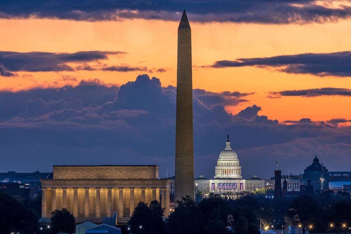 Dawn breaks behind the Lincoln Memorial, Washington Monument, and the U.S. Capitol on Inauguration Day in Washington, Wednesday, Jan. 20, 2021. President-elect Joe Biden will be sworn in as the 46th President of the United States of America at noon.